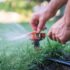 hands adjusting a Sprinkler